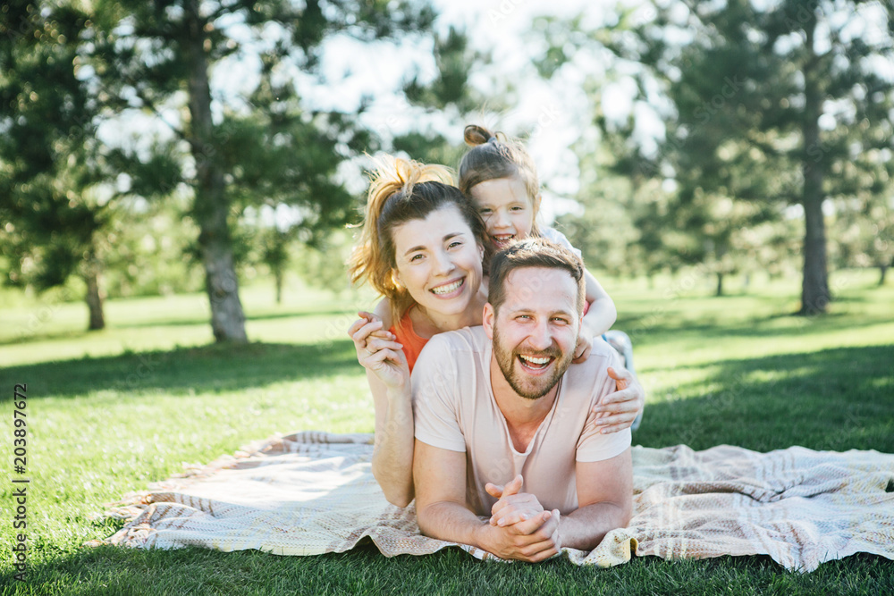 Fototapeta premium Happy family rest in park.