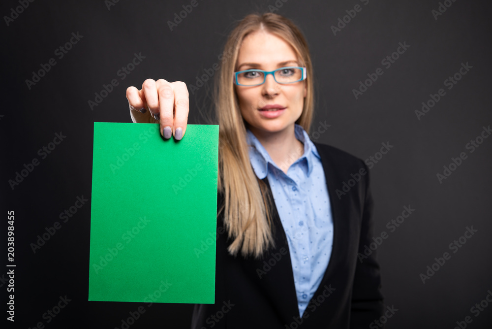 Naklejka premium Selective focus of business lady holding green cardboard.