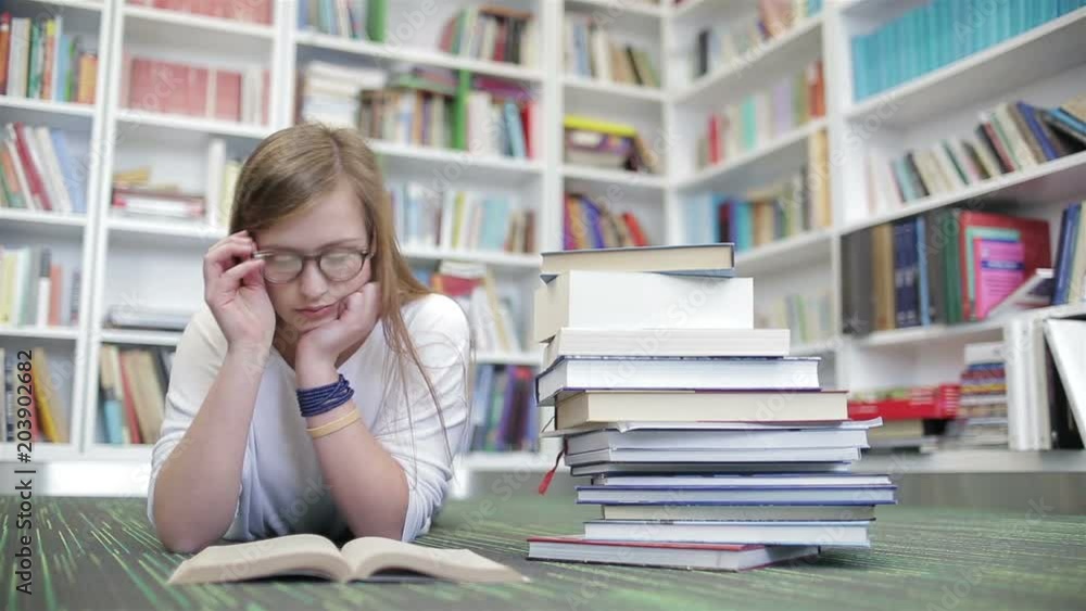 smart looking famale student girl in collage school library reading book smart looking famale student girl in collage school library reading book