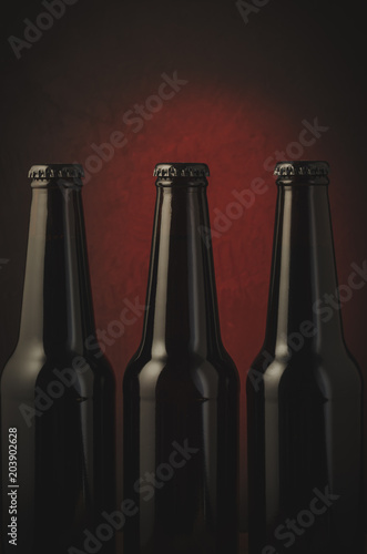 black bottles of beer/black bottles of beer on a red background.