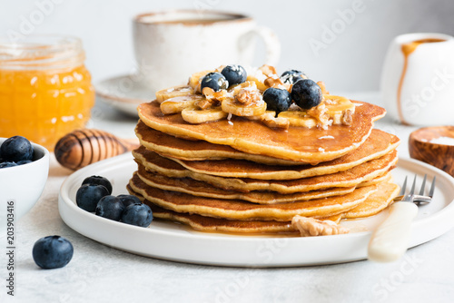 American Pancakes with Blueberries, Walnuts, Honey. Healthy Breakfast Pancakes. Homemade Pancakes. Closeup view, selective focus