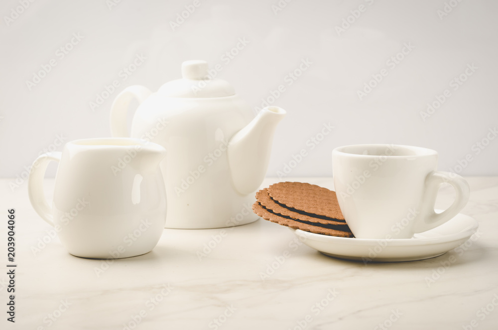 breakfast in white ceramic ware and cookies/breakfast in white ceramic ware and cookies on white marble background