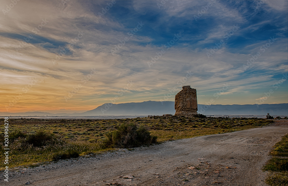 Landscape at sunset with an old tower