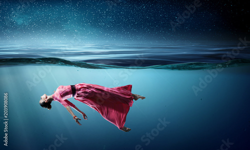 Woman dancer in clear blue water photo