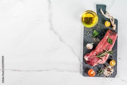 Raw beef meat with spices top view copy space