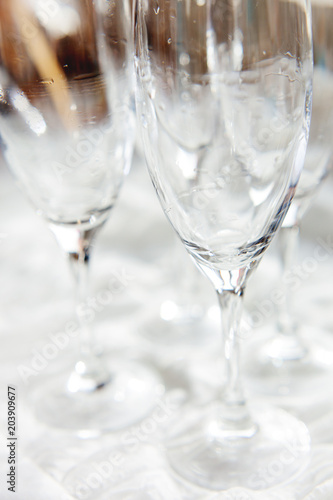 Wet transparent drinking glasses, clear wineglasses after washing.