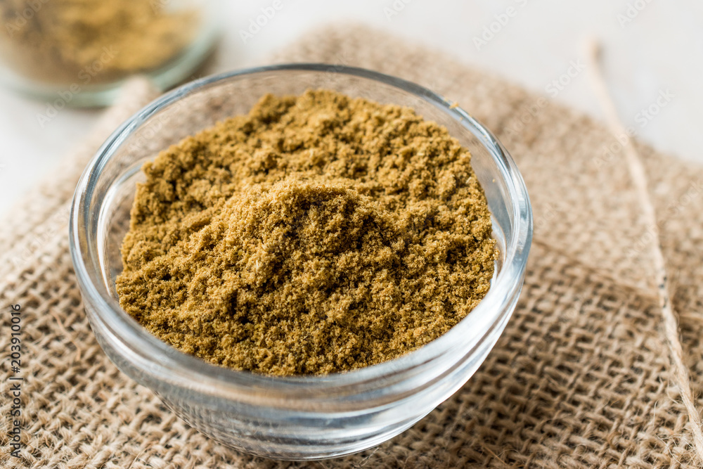 Cumin Powder in Glass Bowl with sack Cumin Powder in Glass Bowl with sack