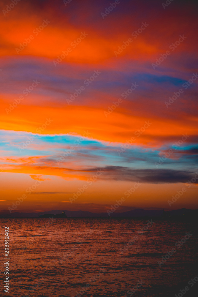 Dramatic bright vivid orange marine sunset