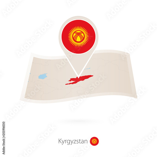 Folded paper map of Kyrgyzstan with flag pin of Kyrgyzstan. photo