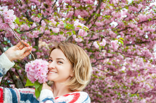 Spring allergy. Beautiful woman enjoying nature blooming tree.