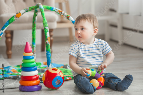 Cute little child playing indoors. Pretty infant baby boy photo