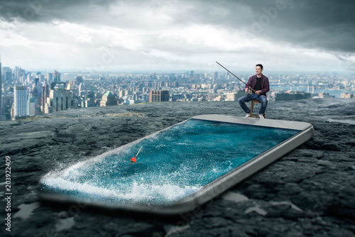 Man fishing in the smartphone screen with water photo