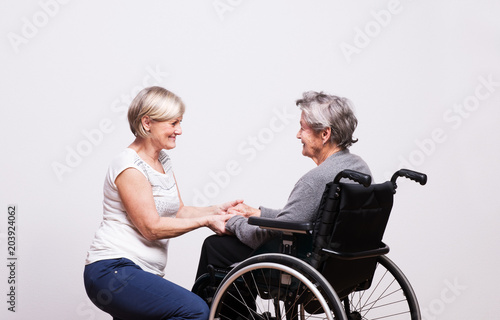 Studio portrait of a senior women in wheelchair. © Halfpoint