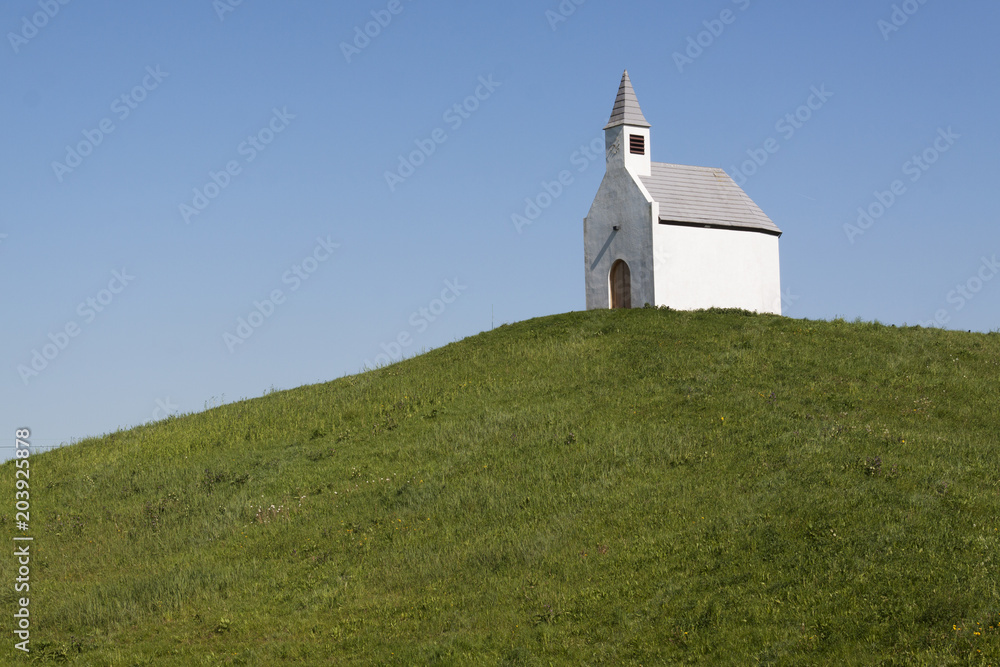 White chapel on a green hill