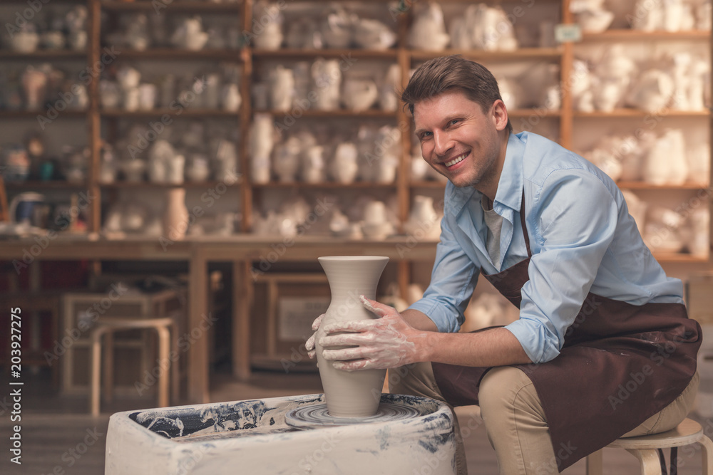 Smiling man at the potter's wheel Smiling man at the potter's wheel