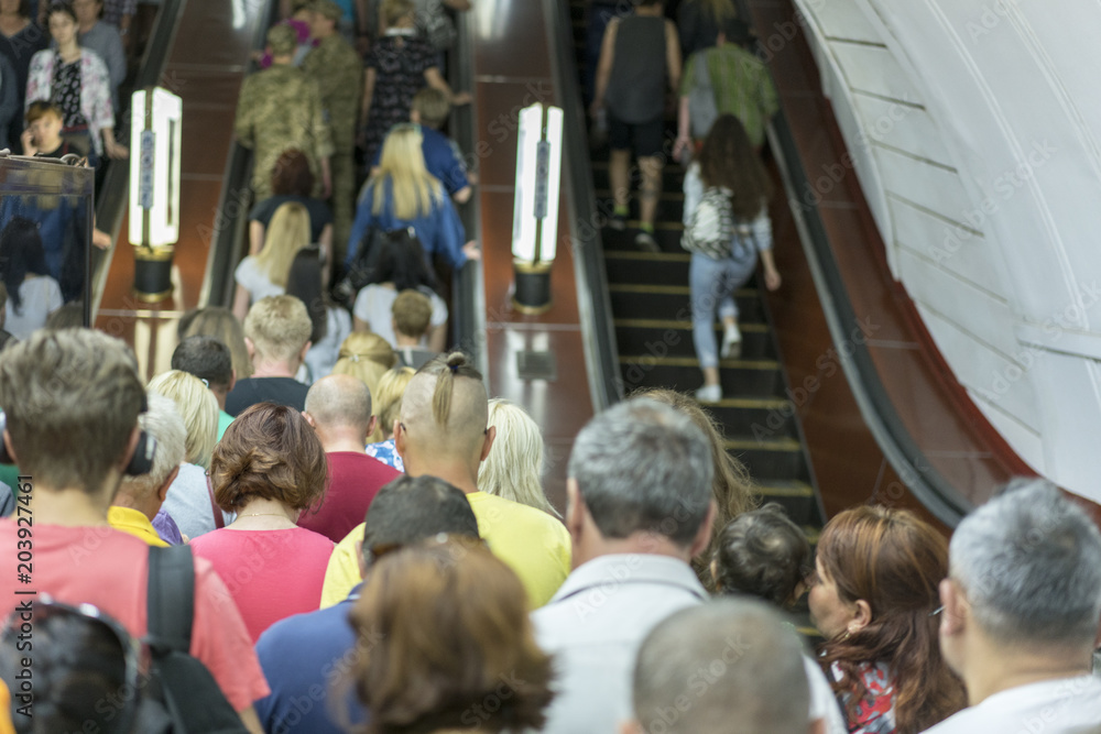 People on the escalator in the Metro. people in escalators