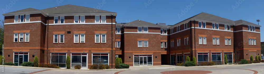 Panorama of brick office building under blue sky. Nobody. Panorama of brick office building under blue sky. Nobody.