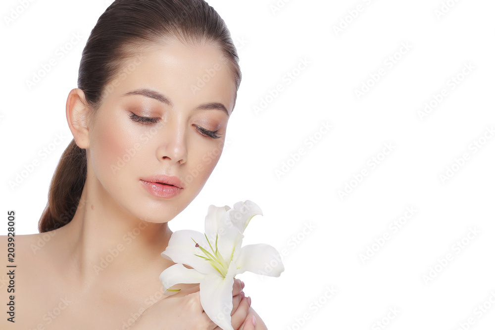Portrait of a beautiful young woman with a flower of lily Portrait of a beautiful young woman with a flower of lily