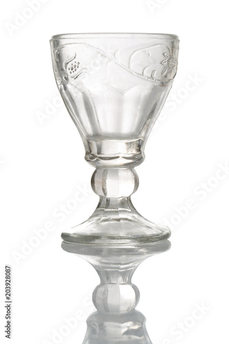 A crystal carved glass of wine isolated on white background.