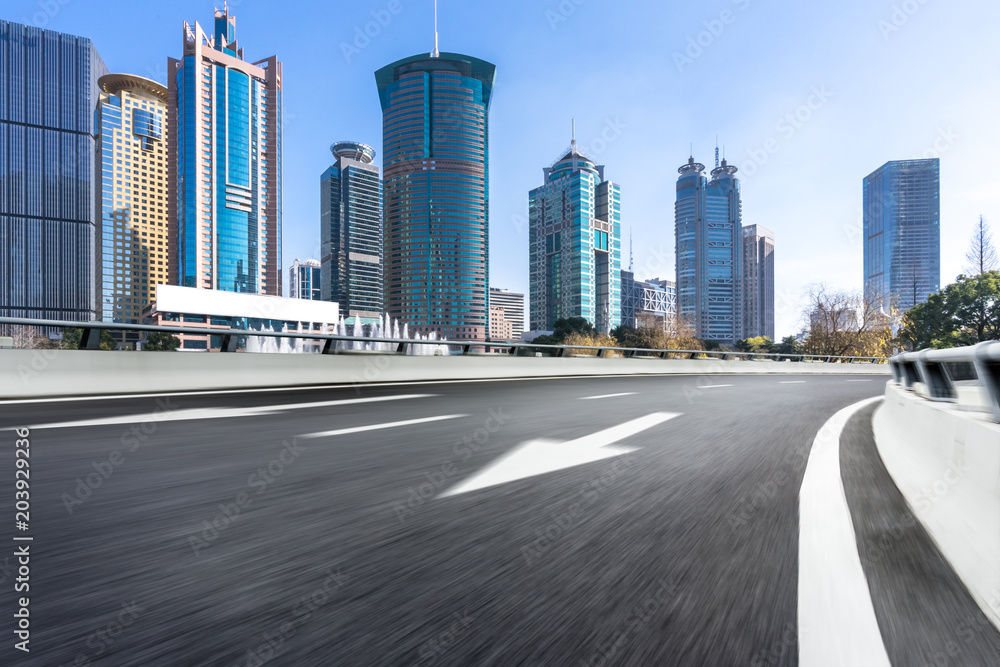 empty asphalt road with modern office building empty asphalt road with modern office building