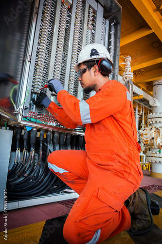Electrical and instrument technician troubleshooting on programmable logic controller of oil and gas production system