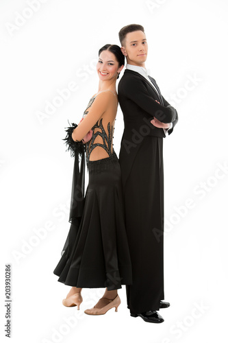 Fashion couple pose isolated on white. Couple in love of ballroom dancers. Sexy woman in black dress and confident man in tuxedo. Valentines day concept. Love date or proposal and family