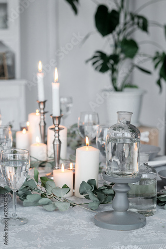 Wedding or festive table setting. Plates, wine glasses, candles and cutlery