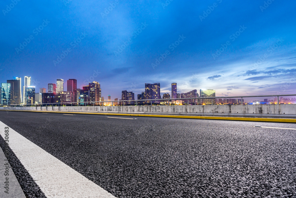 asphalt road with modern office building asphalt road with modern office building