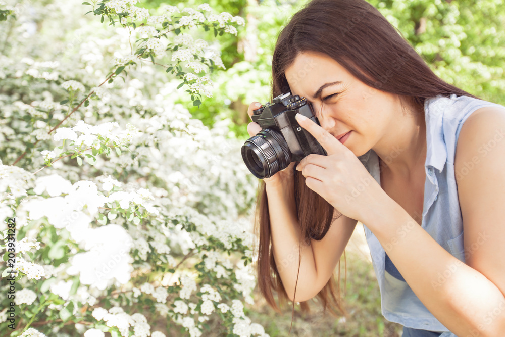 Female photographed nature with retro old camera Female photographed nature with retro old camera