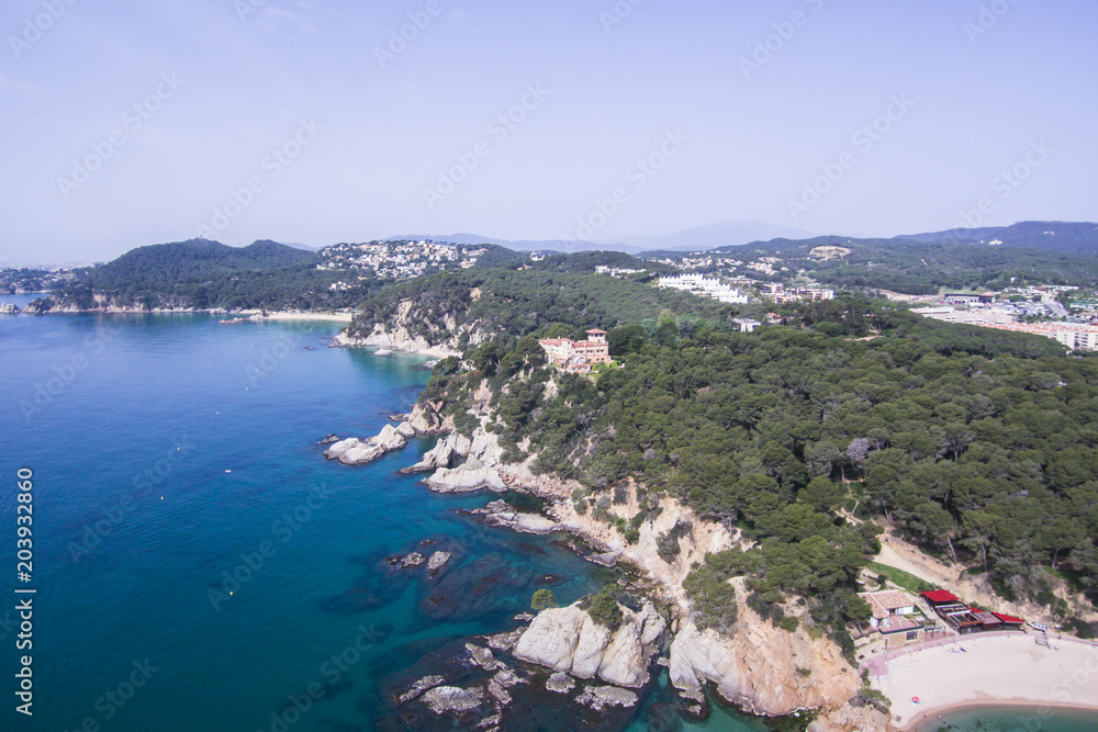 Aerial view of the rocks in the sea on a sunny day in the Costa Brava in Spain