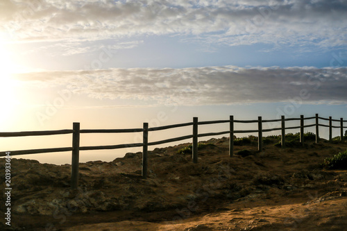 Atlantic ocean with wooden fence on a beautiful summer day with blue sky