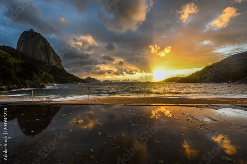 Sunsire at Praia Vermelha (Vermelha beach) with Pao de Acucar (Sugar Loaf Mountain) on the background. Rio de Janeiro, Urca, Brazil
