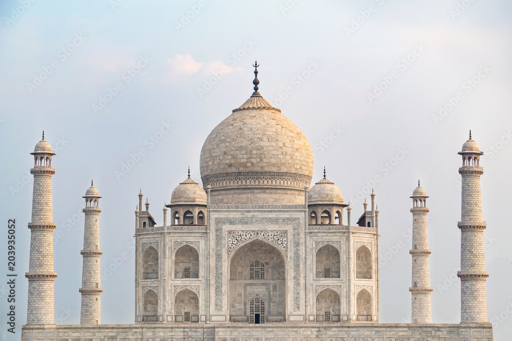 Fototapeta premium Taj Mahal front view reflected on the reflection pool, an ivory-white marble mausoleum on the south bank of the Yamuna river in Agra, Uttar Pradesh, India. One of the seven wonders of the world.