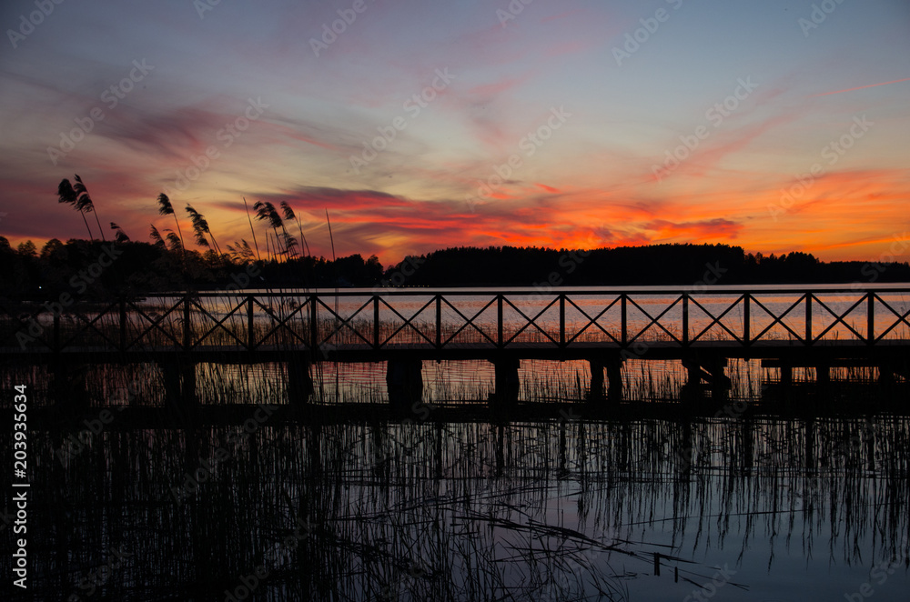 Wooden bridge on a lake at sunset. masuria, Poland