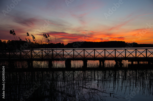 Wooden bridge on a lake at sunset. masuria  Poland