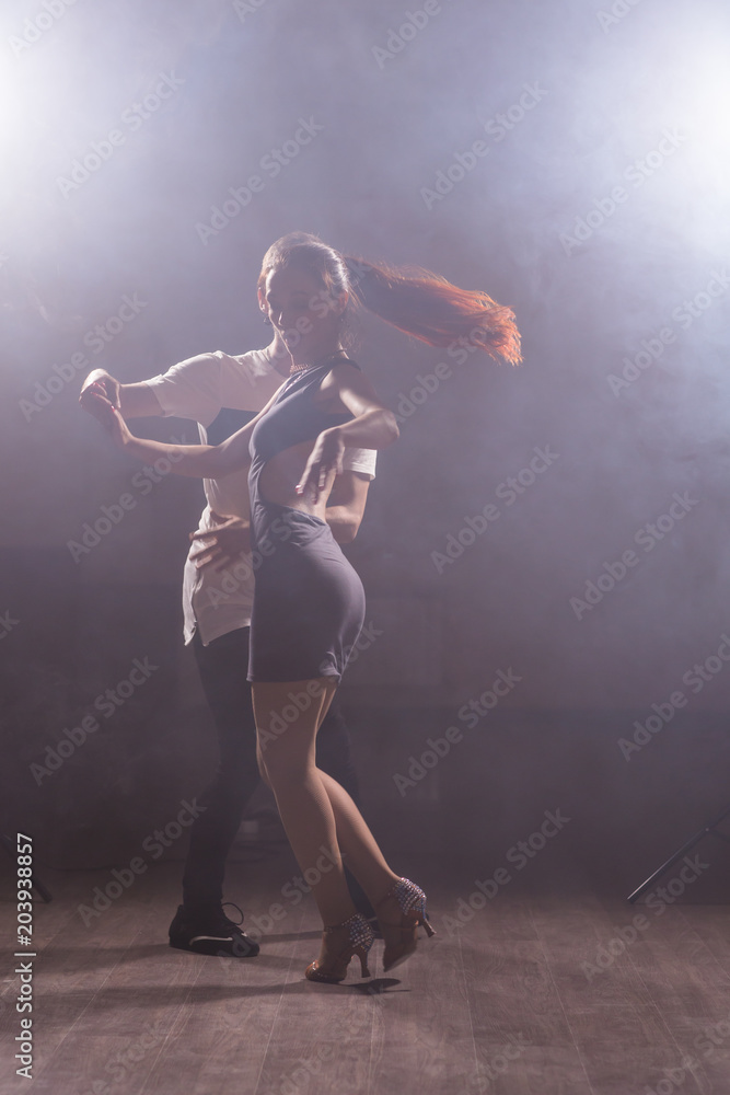 Young couple dancing latin dance Bachata, merengue, salsa. Two elegance pose in dance class Young couple dancing latin dance Bachata, merengue, salsa. Two elegance pose in dance class