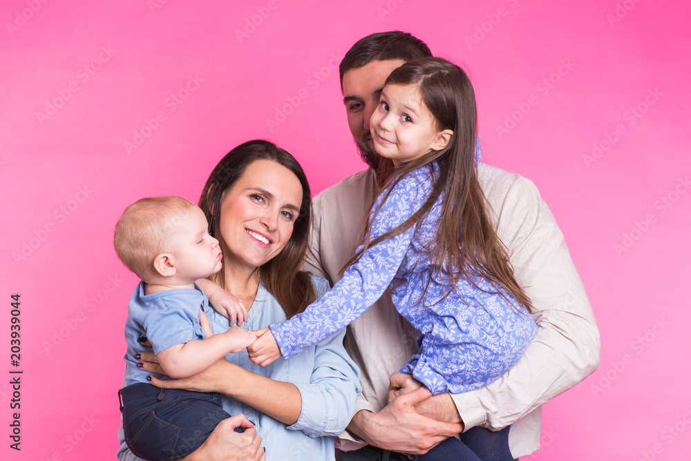 Portrait of Young Happy Mixed Race Family over pink background. Portrait of Young Happy Mixed Race Family over pink background.