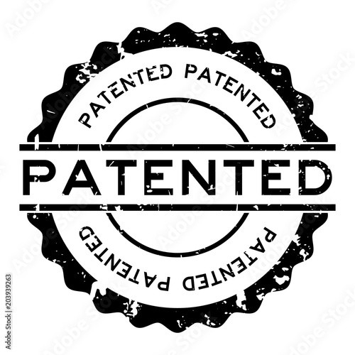 Grunge black patented word round rubber seal stamp on white background