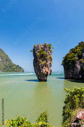 Beautiful limestone cliffs and jungle jutting out of a shallow tropical ocean
