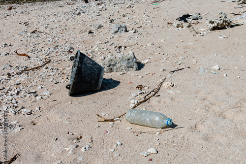 Discarded plastic bottles and other trash on a tropical beach in asia