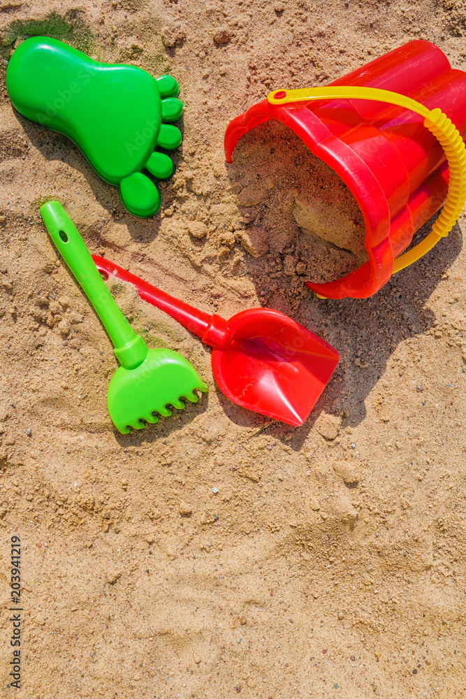 children's sandbox and colorful plastic toys pail bucket and rake for playing outdoors in the summer day concept of development and recreation of children with copy space children's sandbox and colorful plastic toys pail bucket and rake for playing outdoors in the summer day concept of development and recreation of children with copy space