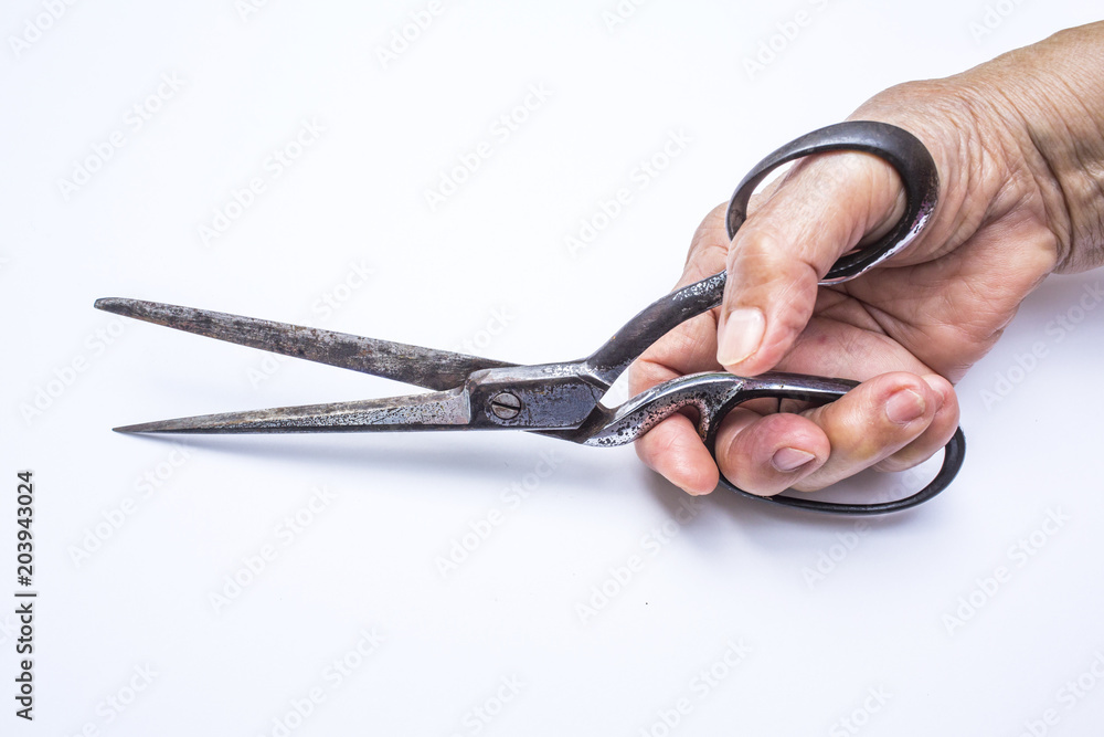 Senior woman's hands holding scissors isolated on white background, About tailor Senior woman's hands holding scissors isolated on white background, About tailor
