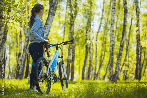 cyclist riding mountain bike in the birch forest © Dmytro Titov