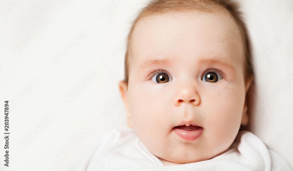 Beautiful small baby face, portrait. Curious little child