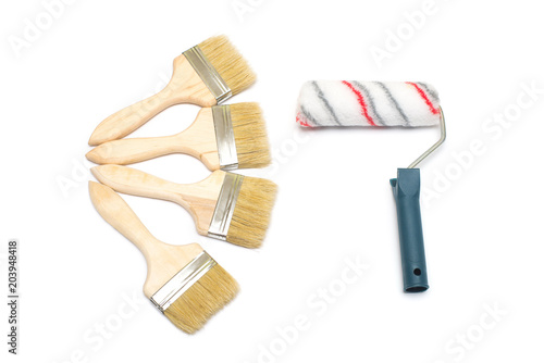 Creative concept comparing brushes and rollers for paint. Flat lay, top view