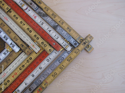 Rulers and scales in metric and inches form a chevron chart or graph representing accuracy, measurement, increase, growth and results with copy space.