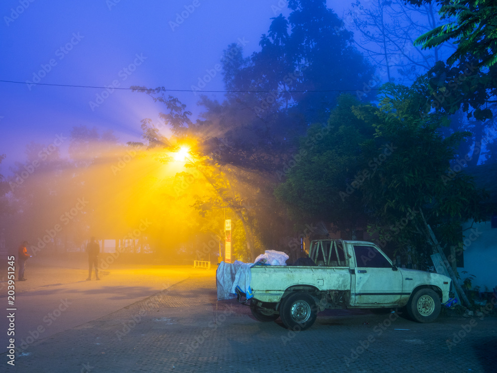 Old pickup truck in the mist with sun ray