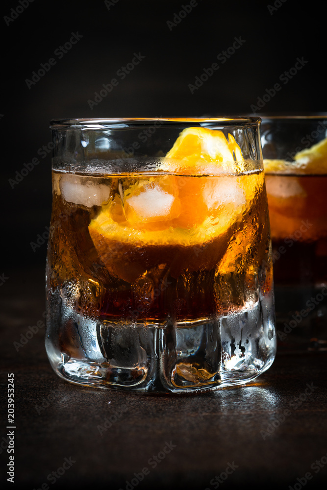Negroni cocktail in glass on dark. Negroni cocktail in glass on dark.