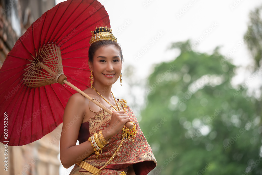 Beautiful asian women in traditional Thai dress with antique red umbrella .  Beauty fantasy Thai woman. Beautiful Thai girl in traditional dress  costume, Ang Thong province, Thailand. Stock Photo | Adobe Stock