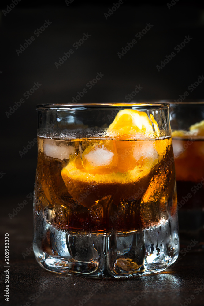 Negroni cocktail in glass on dark. Negroni cocktail in glass on dark.